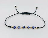 Pulsera Negra Con Ojitos Azules Oro Laminado