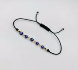 Pulsera Negra Con Ojitos Azules Oro Laminado